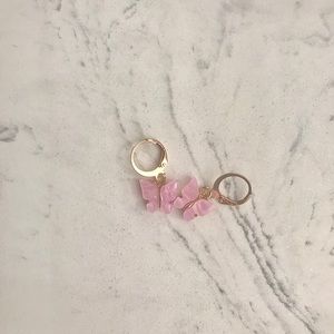 Pink butterfly earrings.